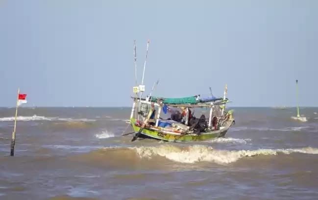 Nelayan menaiki perahu untuk melaut