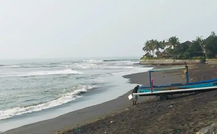Nelayan saat menambatkan jukung di bibir Pantai bali