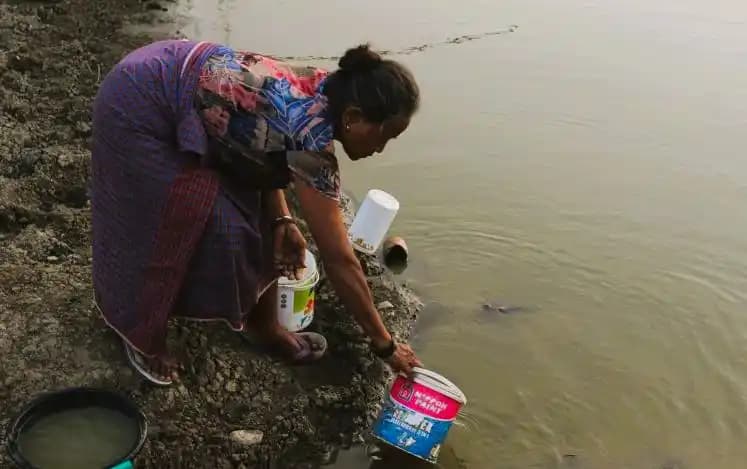 Seorang ibu mengambil air di embung yang keruh, Desa Kabuna, Atambua, Kabupaten Belu.